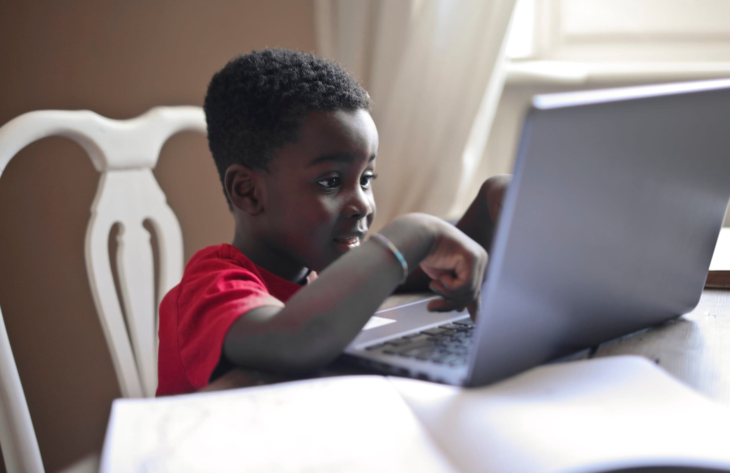 portrait of black child while doing homework
