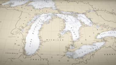 A light brown map of Michigan with the water in very pale blue.